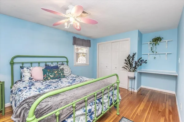 a bedroom with a large bed and a chandelier