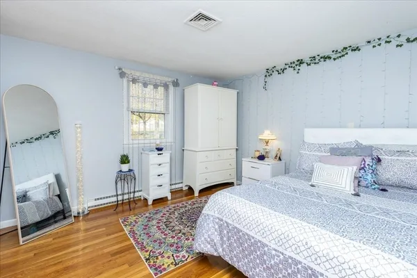 a bedroom with a bed and a dresser