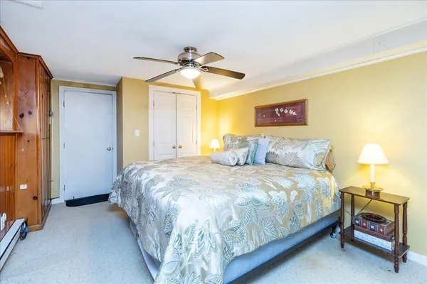 a bedroom with a bed and a lamp