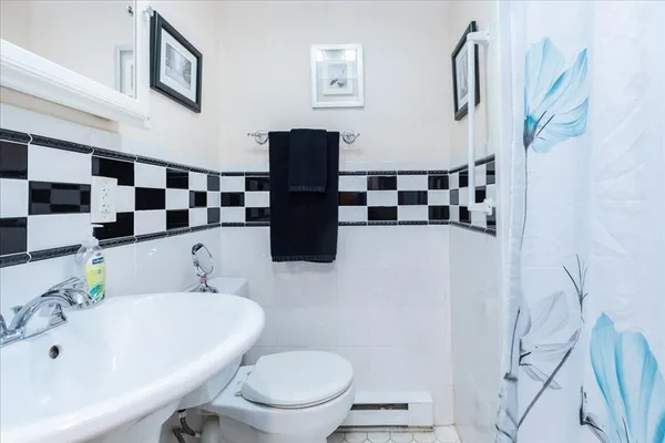 a bathroom with a sink and mirror with toilet