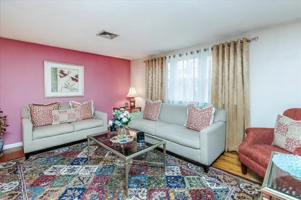 a living room with furniture and a rug