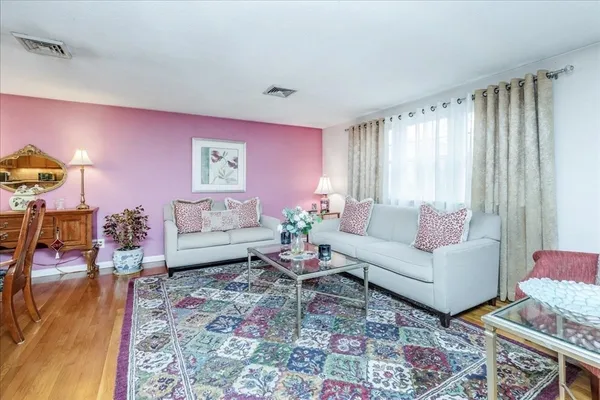 a living room with furniture and a rug
