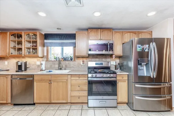 a kitchen with a refrigerator and a sink
