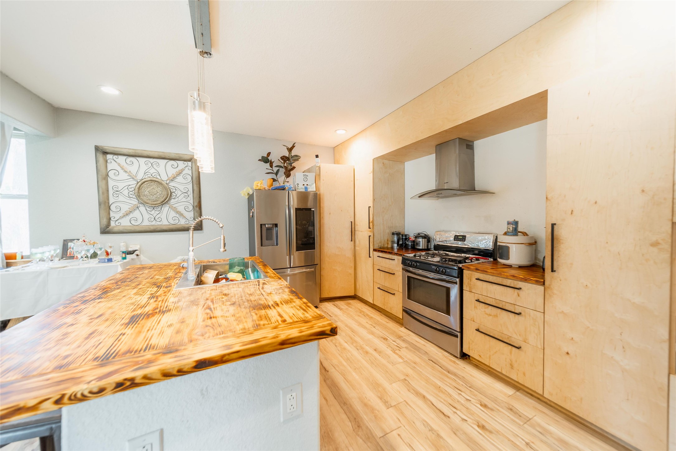 11 Seth Cleveland, TX 77328 - Photo 16 of 50 a kitchen with stainless steel appliances granite countertop a sink stove and refrigerator