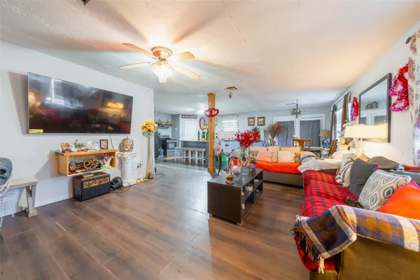 a living room with furniture and wooden floor