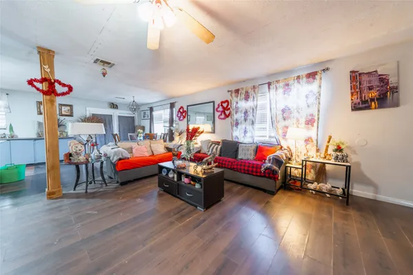 a living room with furniture and a chandelier