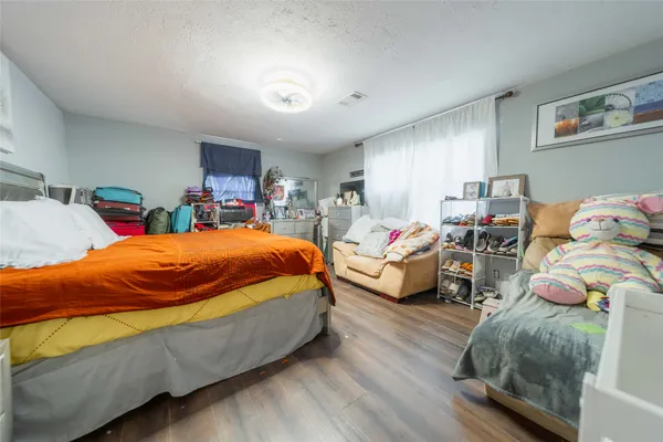 a bed sitting in a bedroom next to a window