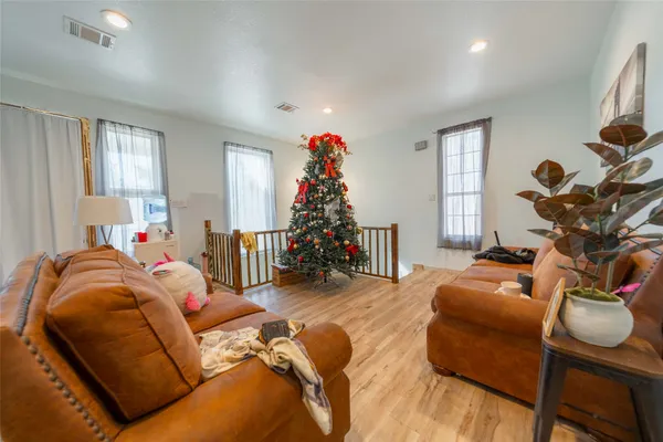 a living room with furniture stairs and a window