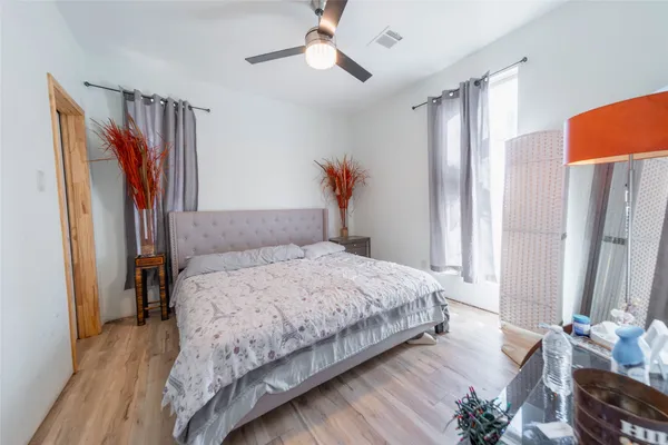 a bedroom with bed and a chandelier