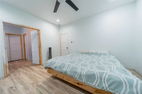 a bedroom with a bed and a painting on the wall