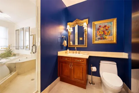 a bathroom with a tub sink and mirror