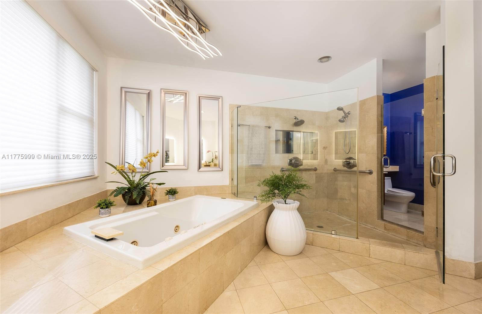 3707 Northeast 214th Street, Unit 14 Aventura, FL 33180 - Photo 26 of 47 a bathroom with a tub sink and mirror