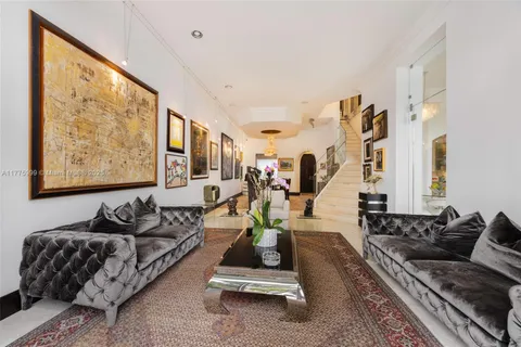 a living room with furniture and painting on the wall