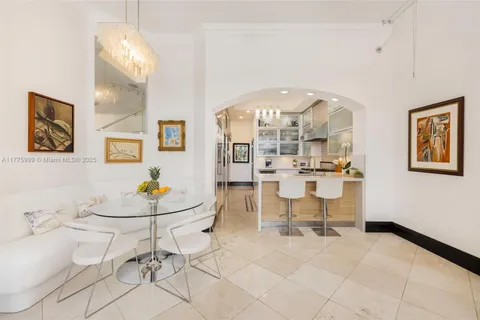 a kitchen with stainless steel appliances kitchen island granite countertop a refrigerator and a sink