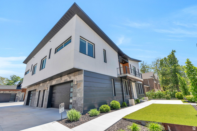 7045 South 300 East Midvale, UT 84047 - Photo 38 of 49 Modern architectural facade featuring white and dark gray siding with stone accents