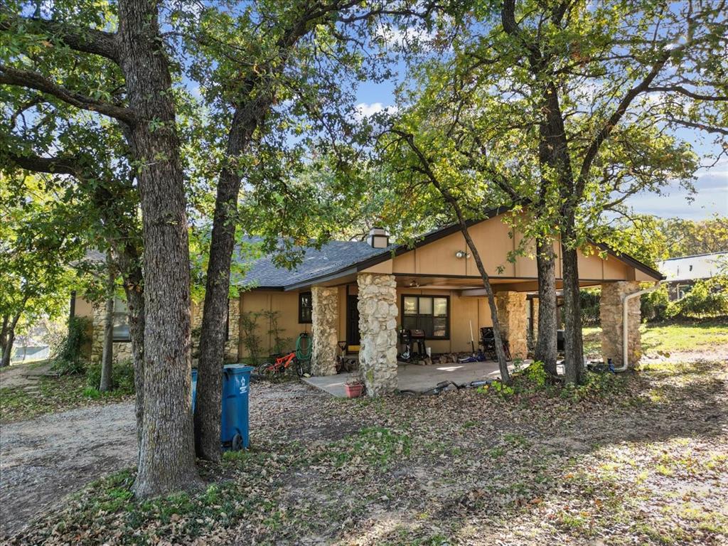 8123 Hilltop Road Argyle, TX 76226 - Photo 17 of 34 a view of a house with a yard