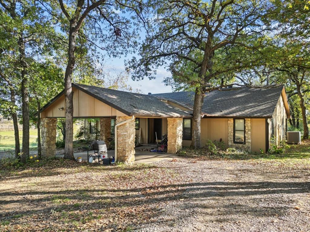 8123 Hilltop Road Argyle, TX 76226 - Photo 18 of 34 a front view of house with yard and trees around