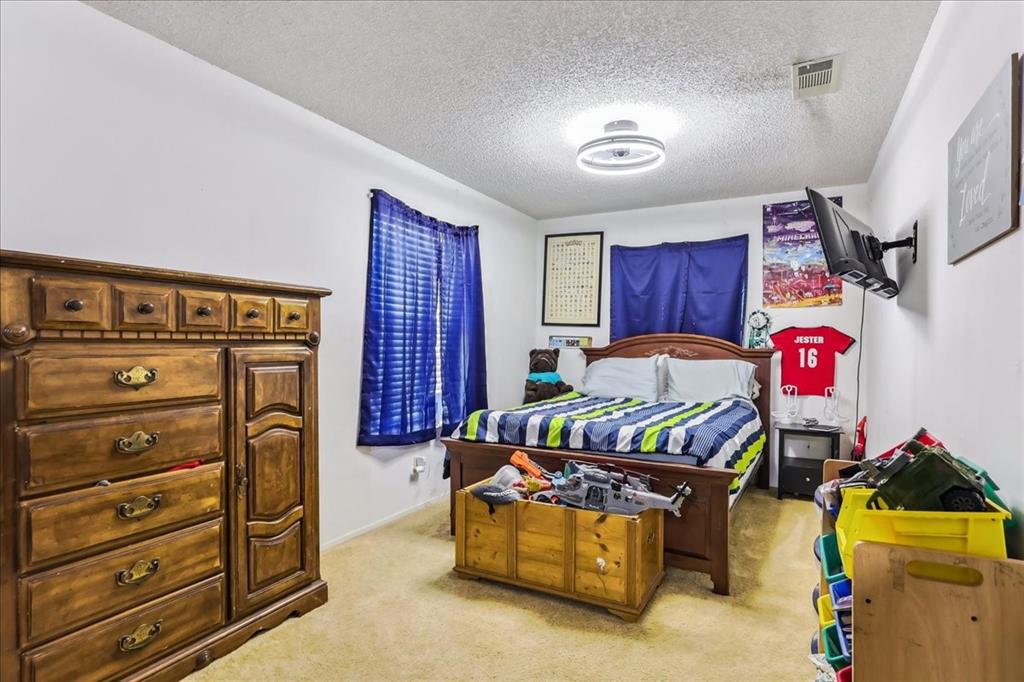 8123 Hilltop Road Argyle, TX 76226 - Photo 22 of 34 a bedroom with a bed and a couch