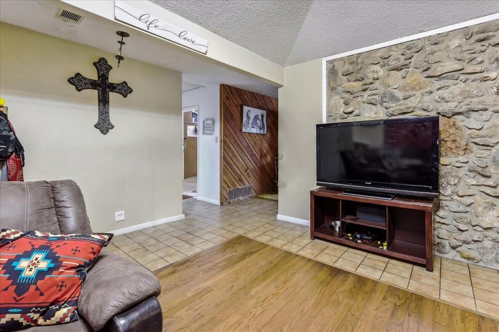 8123 Hilltop Road Argyle, TX 76226 - Photo 24 of 34 a living room with furniture and a flat screen tv