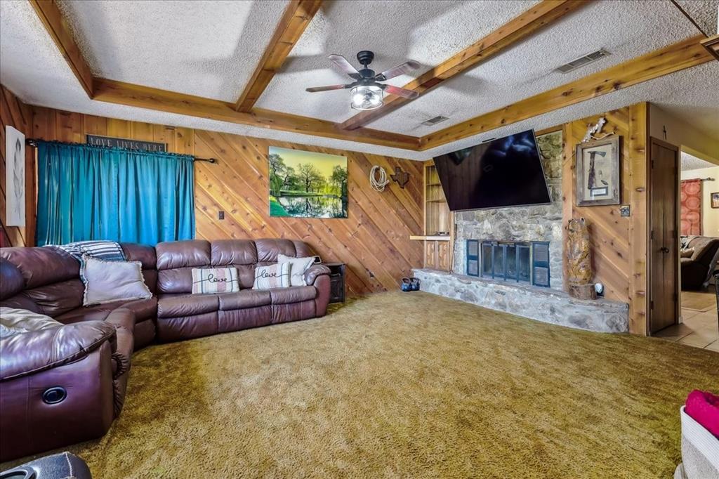 8123 Hilltop Road Argyle, TX 76226 - Photo 25 of 34 a living room with furniture a flat screen tv and a fireplace