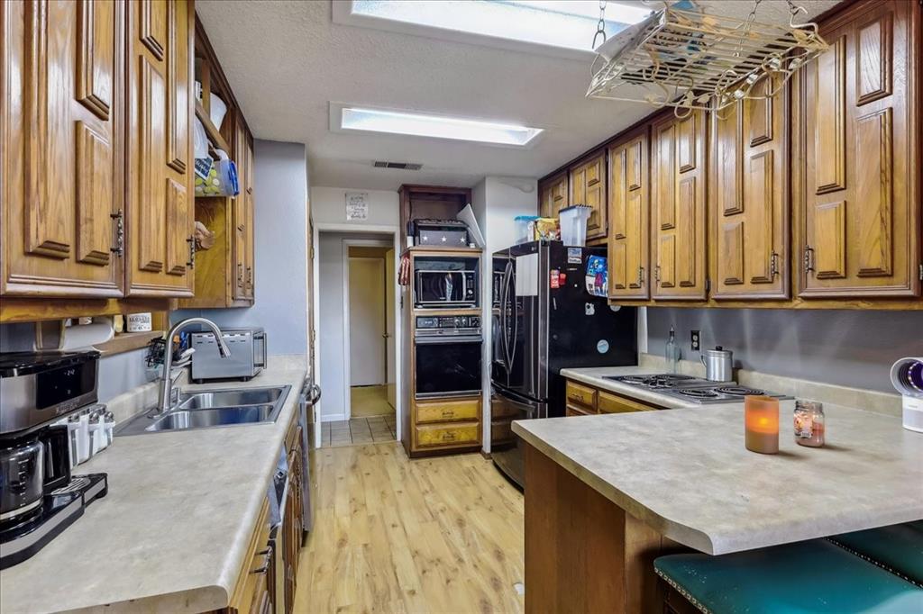 8123 Hilltop Road Argyle, TX 76226 - Photo 27 of 34 a kitchen with stainless steel appliances granite countertop a refrigerator and a stove top oven