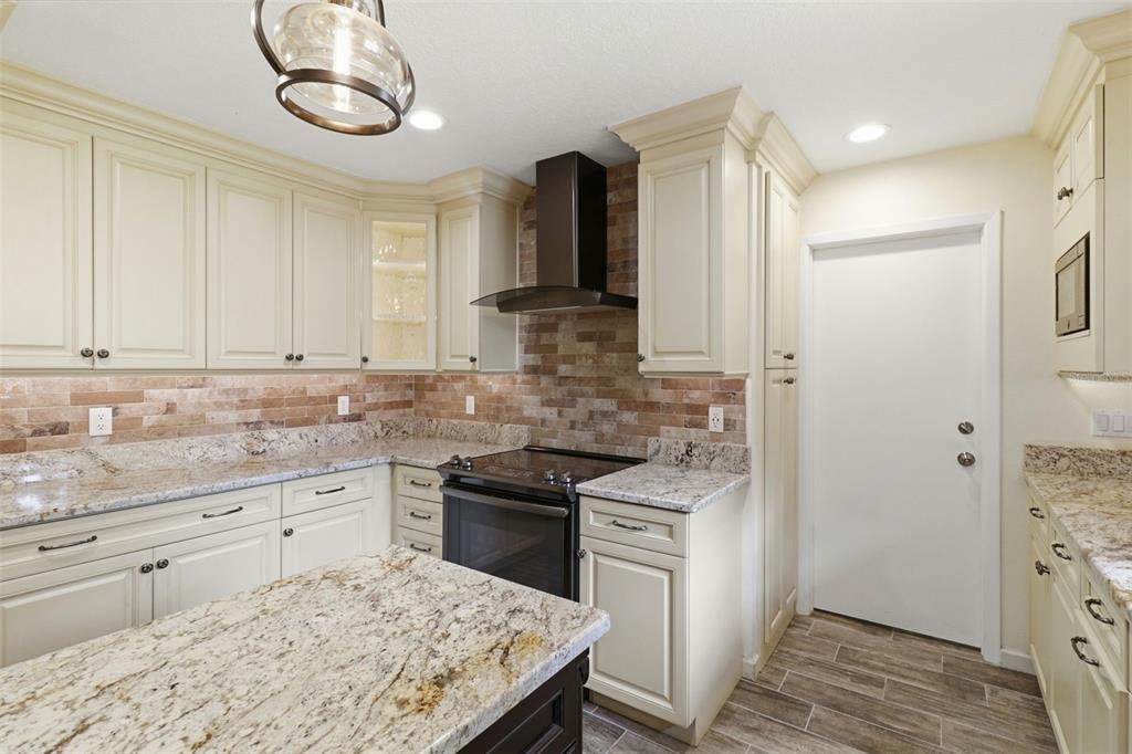 302 Bloomingfield Drive Brandon, FL 33511 - Photo 13 of 58 a kitchen with stainless steel appliances granite countertop a sink and stove top oven