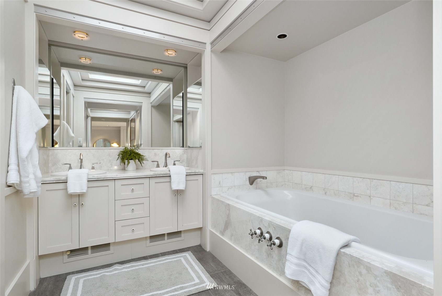2315 216th Place Northeast Sammamish, WA 98074 - Photo 21 of 38 a bathroom with a bathtub sink and mirror