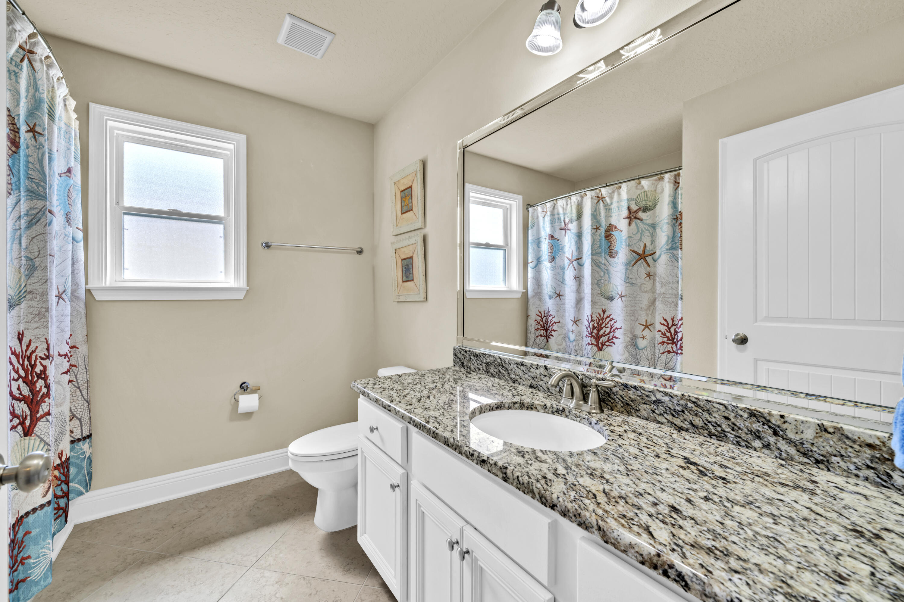 19 Topside Drive Inlet Beach, FL 32461 - Photo 18 of 28 a bathroom with a granite countertop sink mirror vanity and toilet