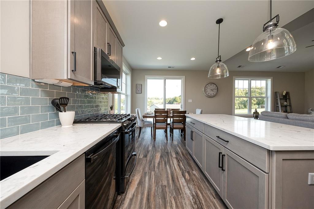 103 Ridge Line Drive Apollo, PA 15613 - Photo 21 of 39 a kitchen with stainless steel appliances granite countertop a sink a stove and a wooden floors