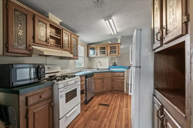 a kitchen with stainless steel appliances granite countertop a stove and a sink