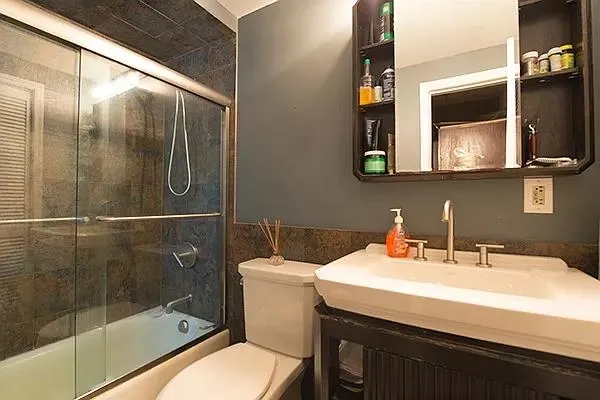 a bathroom with a sink toilet and shower