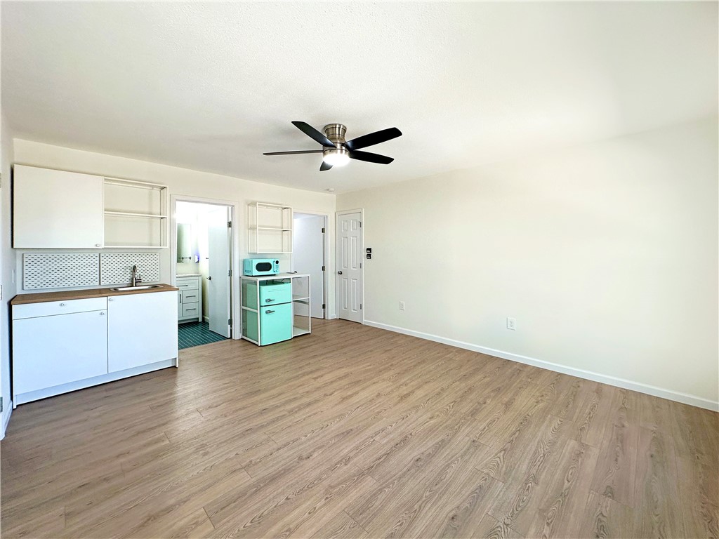 202 Ranch Road Mathis, TX 78368 - Photo 26 of 36 a view of a kitchen with a sink and a refrigerator