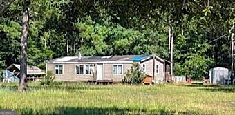 1409 Courthouse Rd Extension Guyton, GA 31312 - Photo 1 of 1 a view of a house with a yard and plants