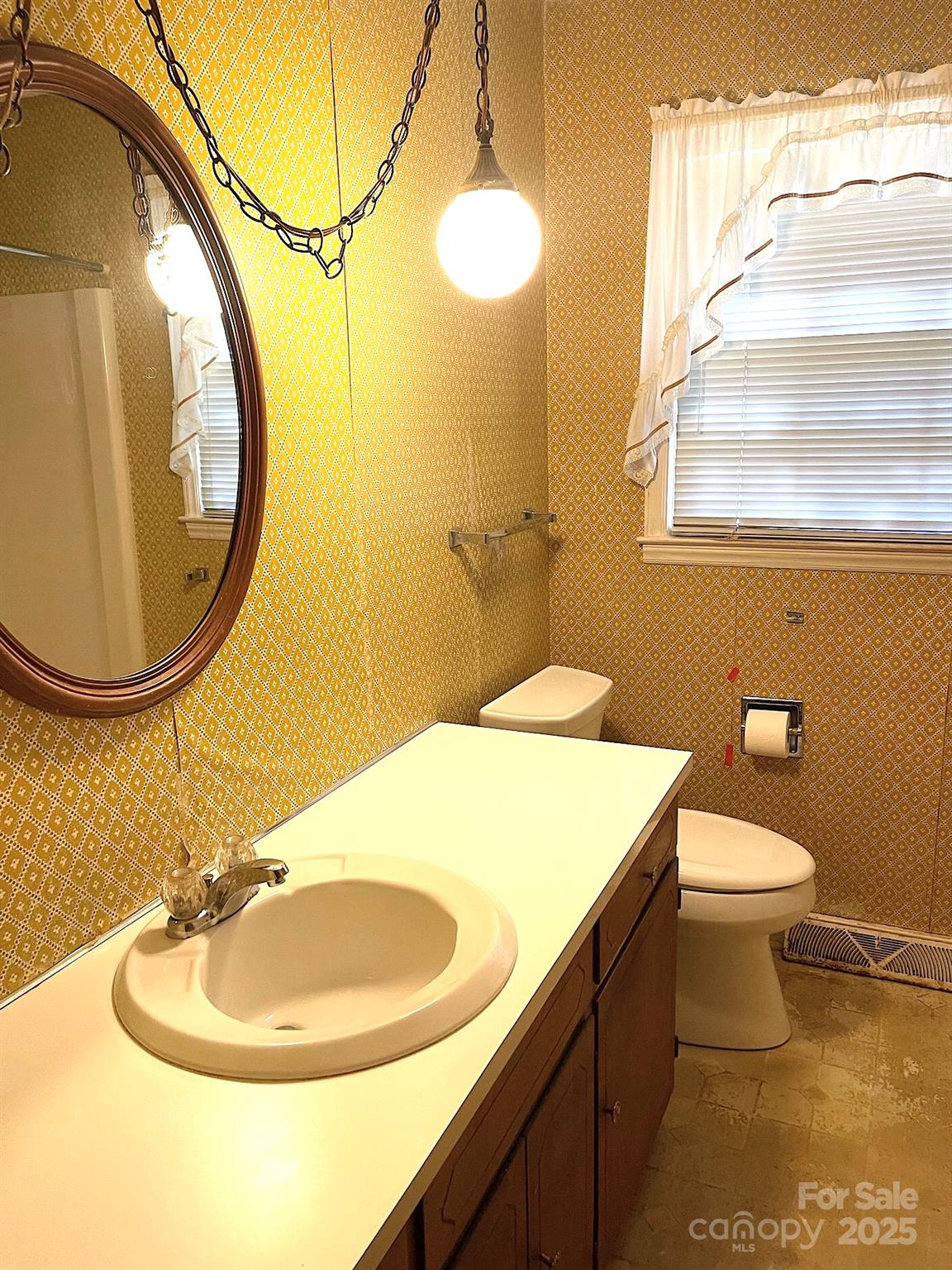 108 Nottingham Street York, SC 29745 - Photo 7 of 12 a bathroom with a sink a mirror and a toilet