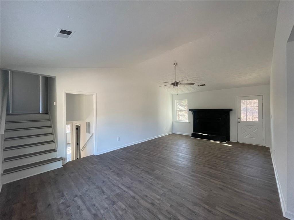 3417 Hollow Tree Drive Decatur, GA 30034 - Photo 3 of 10 an empty room with wooden floor fireplace and windows