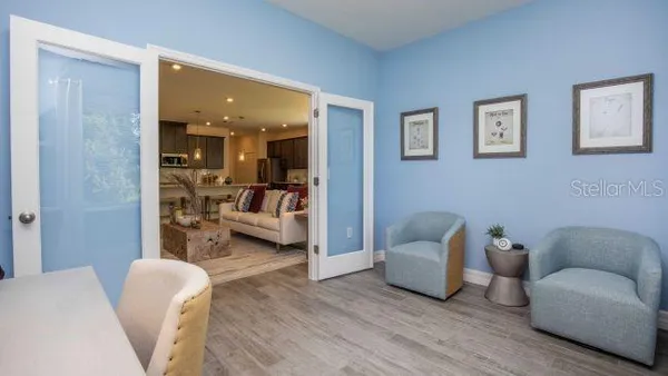 a bedroom with bed and wooden floor