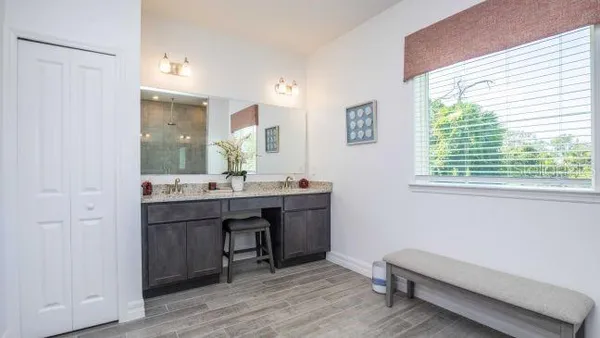 a bathroom with a granite countertop sink a toilet and bathtub