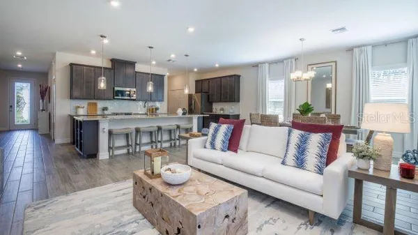 a living room with furniture a table and a flat screen tv