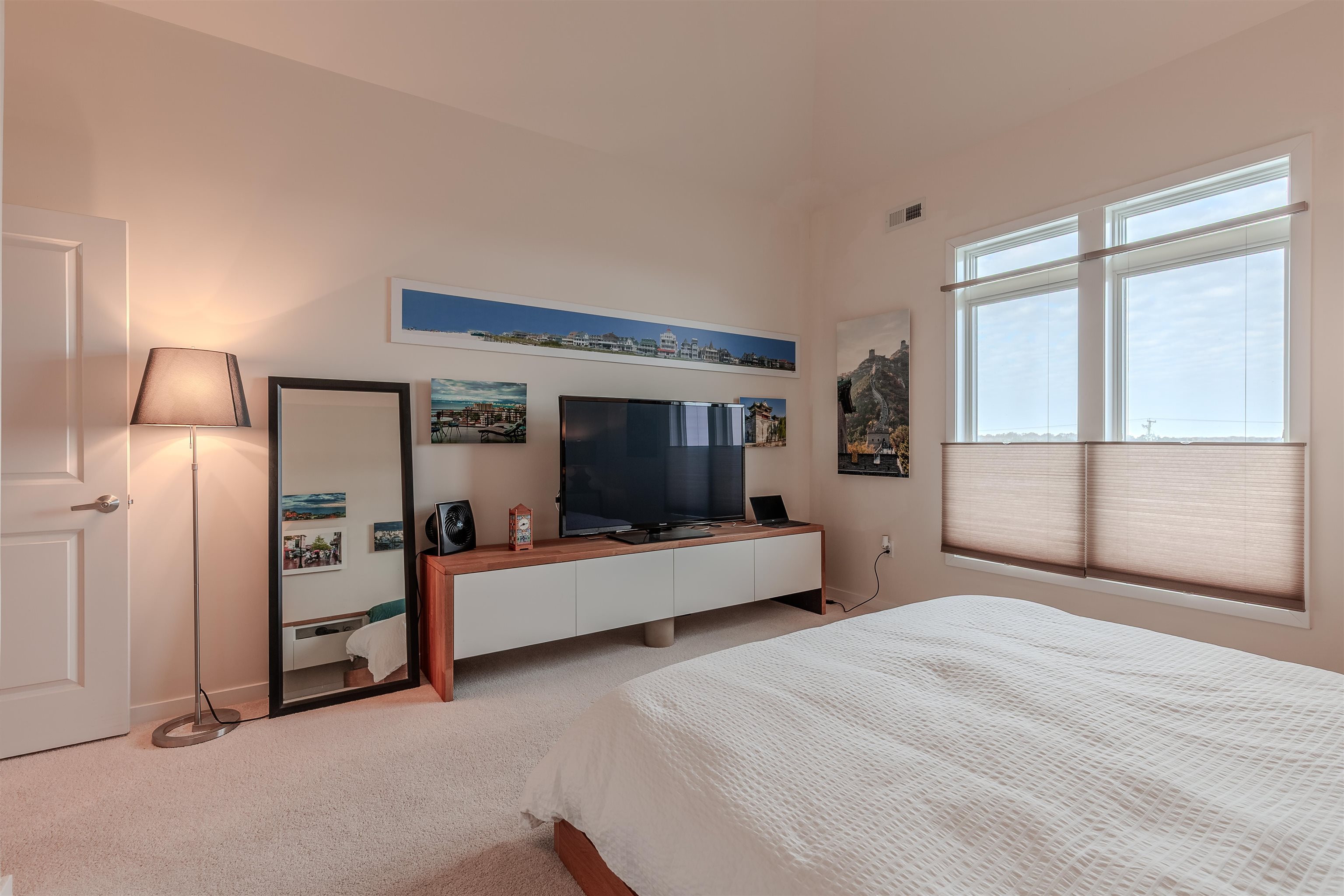 902 Ocean, Unit 106 Cape May, NJ 08204 - Photo 21 of 33 a bedroom with furniture and a large window