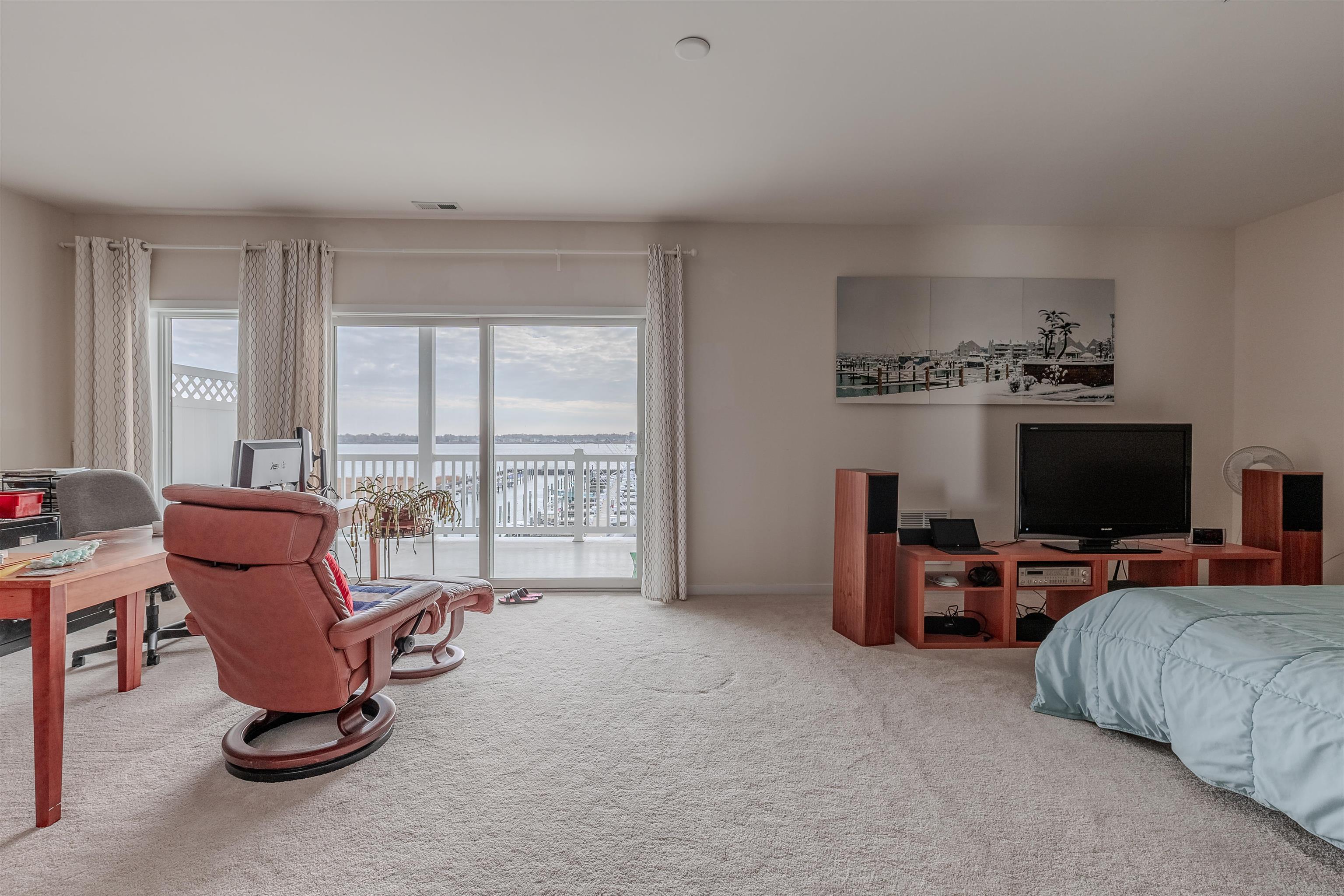 902 Ocean, Unit 106 Cape May, NJ 08204 - Photo 25 of 33 a living room with furniture and a flat screen tv