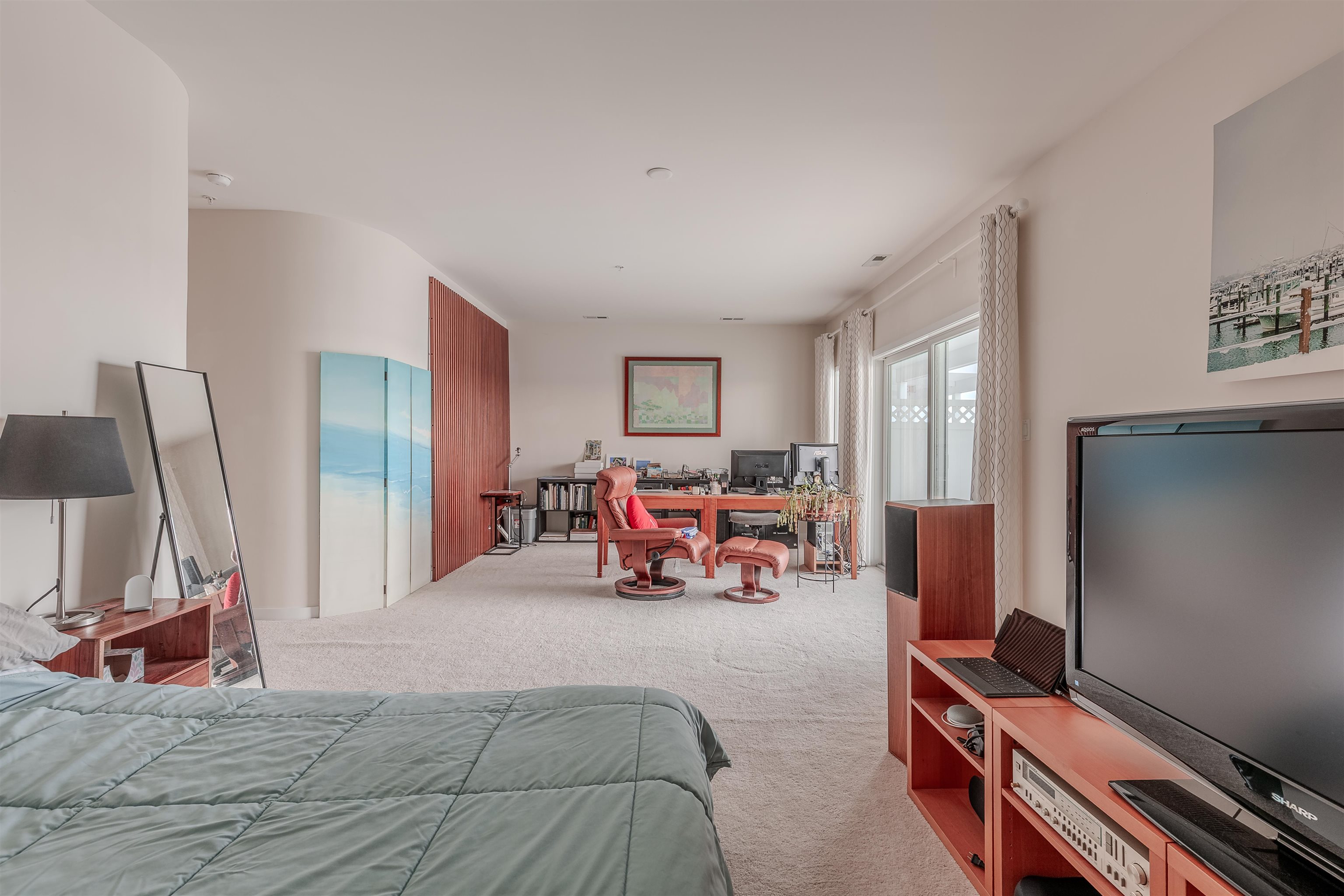 902 Ocean, Unit 106 Cape May, NJ 08204 - Photo 26 of 33 a bed room with furniture and a flat screen tv