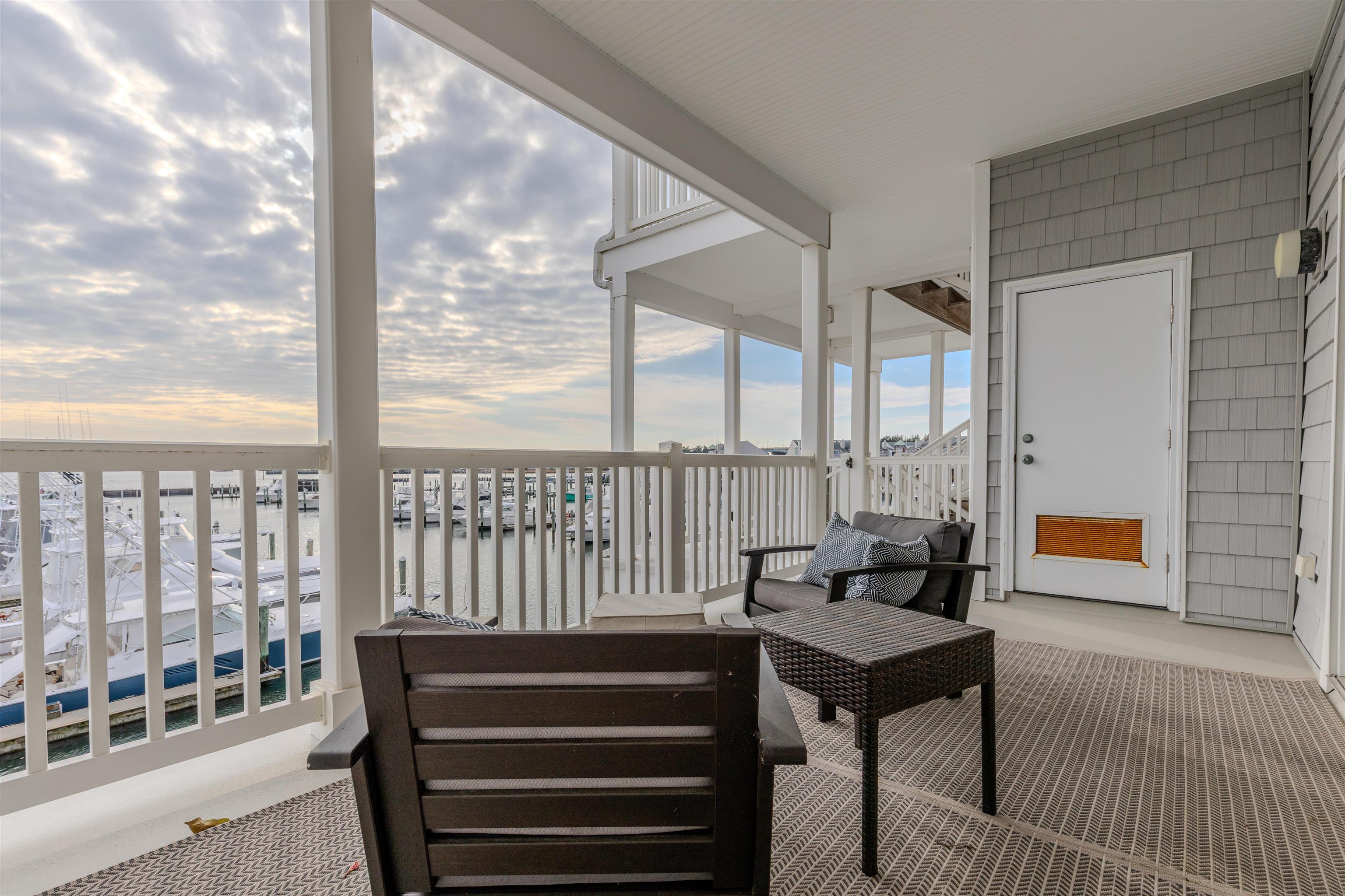 902 Ocean, Unit 106 Cape May, NJ 08204 - Photo 32 of 33 a living room with furniture and a floor to ceiling window