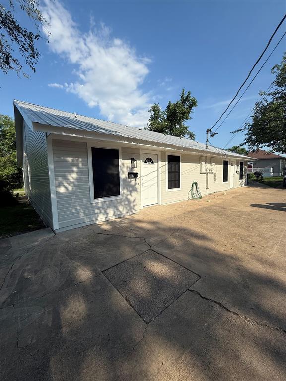 304 East Hickory Street, Unit A Kaufman, TX 75142 - Photo 1 of 12 a view of a house with yard and parking area