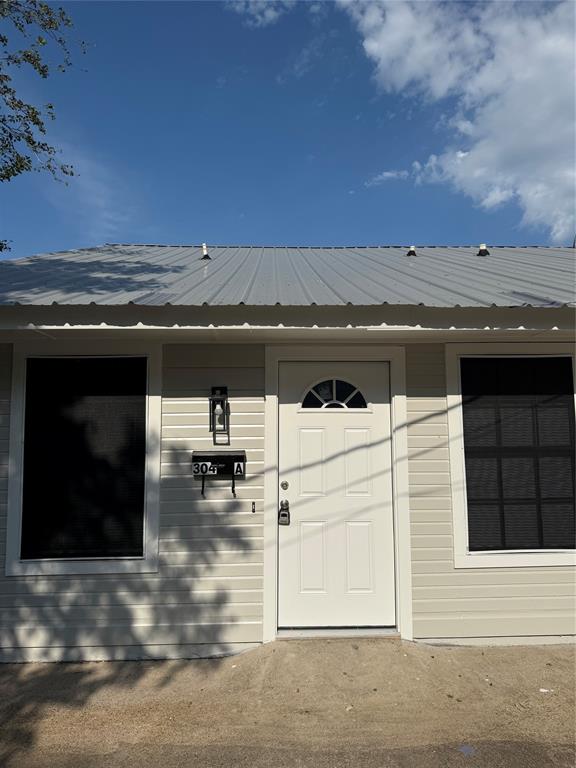 304 East Hickory Street, Unit A Kaufman, TX 75142 - Photo 2 of 12 a view of a terrace with a couch