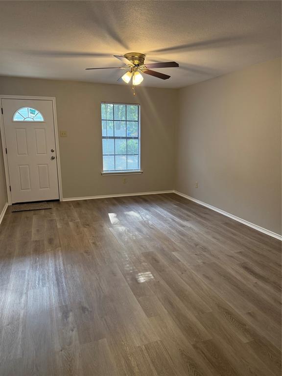 304 East Hickory Street, Unit A Kaufman, TX 75142 - Photo 6 of 12 wooden floor in an empty room
