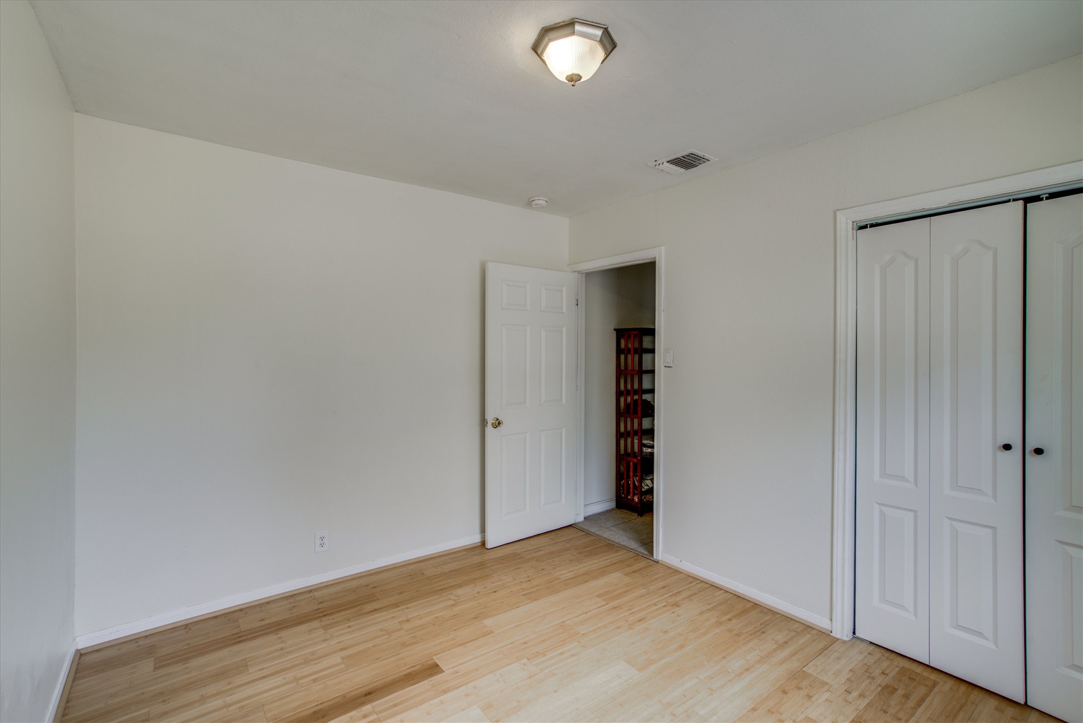 4615 Ribbecke Avenue Austin, TX 78721 - Photo 14 of 19 Unfurnished bedroom featuring light wood-type flooring and a closet