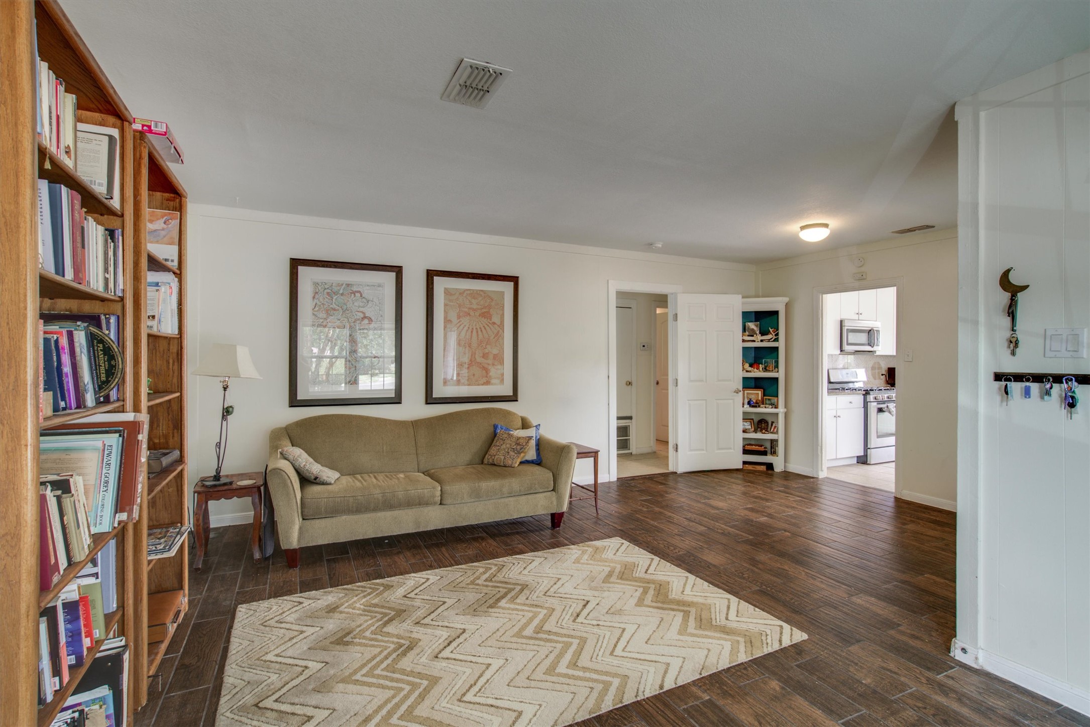 4615 Ribbecke Avenue Austin, TX 78721 - Photo 4 of 19 Living room featuring dark wood-type flooring and crown molding