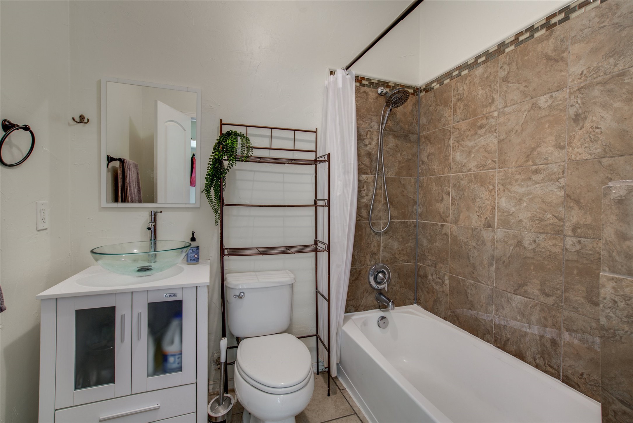 4615 Ribbecke Avenue Austin, TX 78721 - Photo 8 of 19 Full bath with vanity and shower / tub combo with curtain