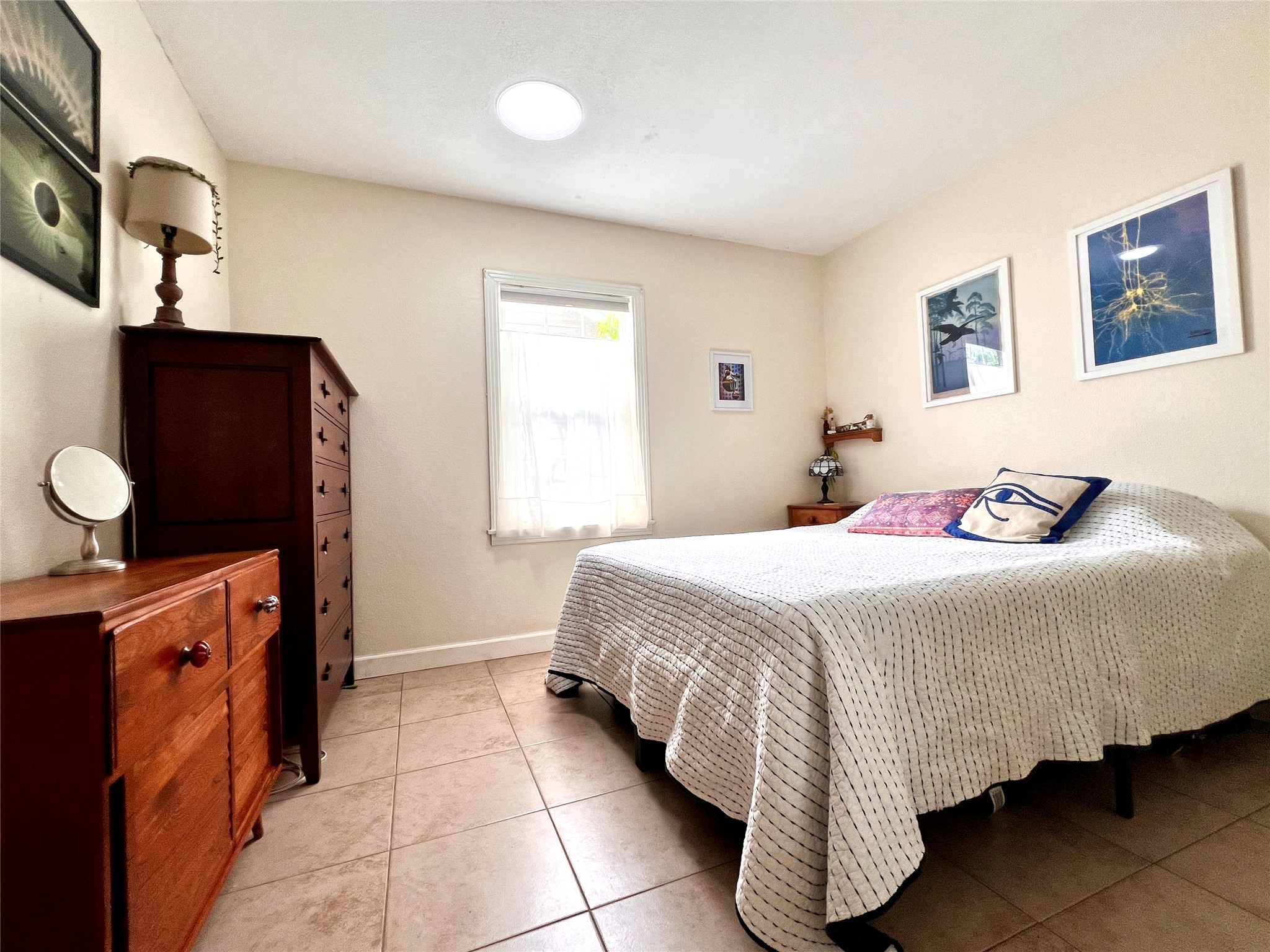 4615 Ribbecke Avenue Austin, TX 78721 - Photo 9 of 19 Bedroom featuring light tile patterned flooring and baseboards