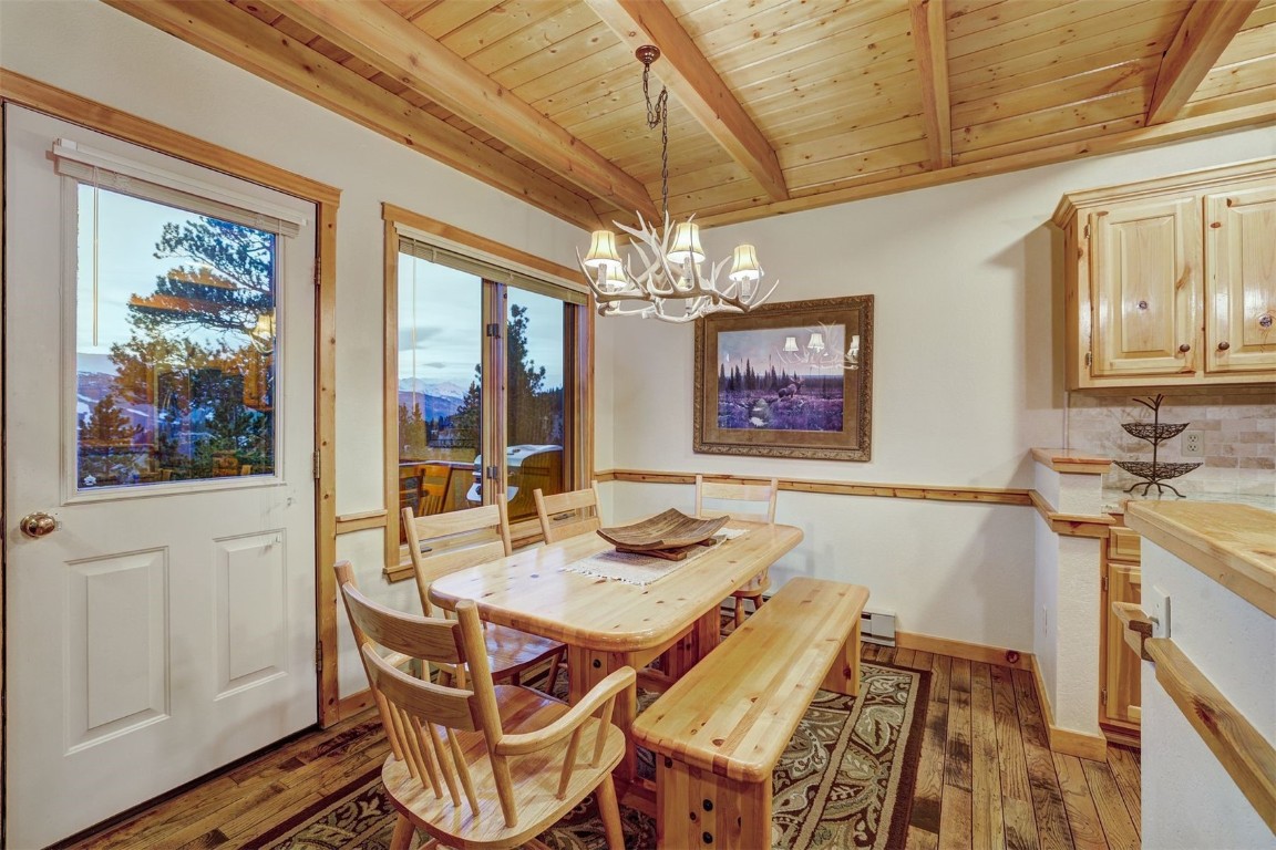 2502 Boreas Pass Road Breckenridge, CO 80424 - Photo 8 of 34 Dining space featuring a chandelier, wood-type flooring, wood ceiling, and beamed ceiling
